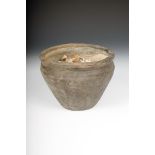 A bronze age earthenware cremation urn, with incised linear decoration to the sides, 15cm high,