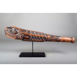 A Northwest Coast fish club, Haida / Tlingit, cedarwood, carved with a totemic animal with exposed