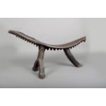A Tikopia coconut grating stool, Melanesia, wood with fibre binding, the underside and legs with