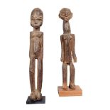 A Lobi standing female figure, Burkina Faso, 32cm high, on a stand and a Lobi standing figure with a