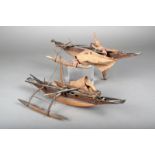 Two Polynesian model outrigger canoes, wood bound with fibre and with sails, 37.7cm long. (2)