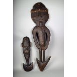 A Papua New Guinea suspension hook, carved with a standing figure, 126cm high, and a smaller