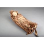 A Northwest Coast basketry doll cradle, wood and fibre, with a fibre and cloth bound cloth doll,