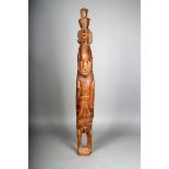 A Massim standing figure, Papua New Guinea, with incised decoration, 98cm high.