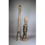 A Papua New Guinea standing male figure, with shell eyes, 86.5cm high, and a Papua New Guinea