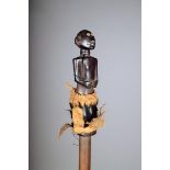 A Bisa staff, Zambia, with a carved standing figural terminal, with an ovoid head, on a metal and