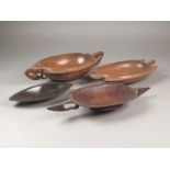 A Tami Islands carved wood bowl, Huon Gulf, oval with bird head lifts, each with a fish, 45.5cm