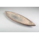 A Sepik shallow bowl, Papua New Guinea, with a dog tooth carved edge, the underside carved an