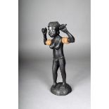 A Solomon Islands carved female figure, ebonised wood, inlaid shell eyes and with arms raised,