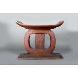 An Ashanti stool, Ghana, with pierced central column, 48cm high. Provenance Dr James Spillius,