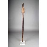 An Aboriginal club, with a pineapple head and a linear carved shaft and terminal, the textured