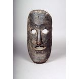 A Gurung mask, Nepal, with metal teeth and with holes around the eyes, mouth and base, wax seal,