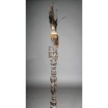 A Batak magician's staff, Indonesia, with ancestor figure, with feathers and fibre above further