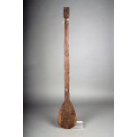 A Marquesas Islands paddle, Polynesia, with a flat ovoid blade and rectangular shaft, carved low