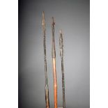 Three African spears, with iron tips, wood shafts and metal counterweights to the bases, 144cm,