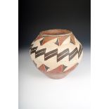 A Navajo pottery jar, with a concave base and banded polychrome decoration in white, red and