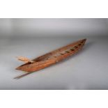 A Great Lakes model canoe, bound wood and bark, with six paddles, 80.5cm long.