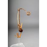 A Solomon Islands fish hook, with a carved shell back and bone hook, with fibre binding, 13.5cm long