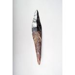 An Admiralty Island dagger, with an obsidian blade and a resin handle, decorated bird motifs and