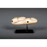 λ An Inuit carved walrus amulet, walrus ivory with pierced suspension hole, baleen eyes and