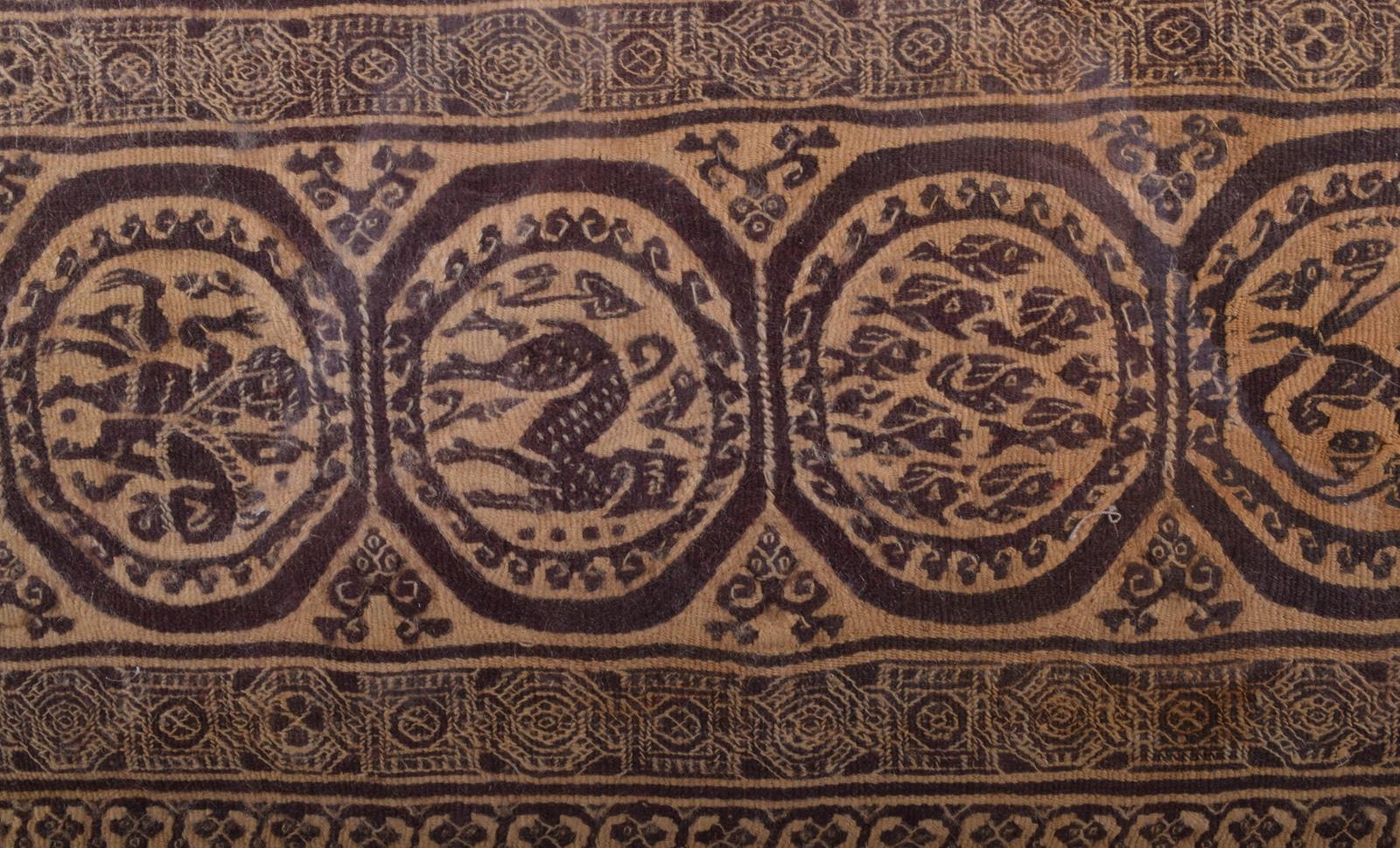 An Egyptian Coptic textile fragment, linen and wool, with a central band of roundels depicting - Image 3 of 3