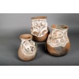 Three Sepik clay storage jars, Papua New Guinea, each modeled with beaked masks, with white pigment,