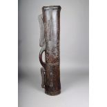 A Massim drum, Trobriand Islands, Papua New Guinea, cylindrical with carved scroll decoration, a