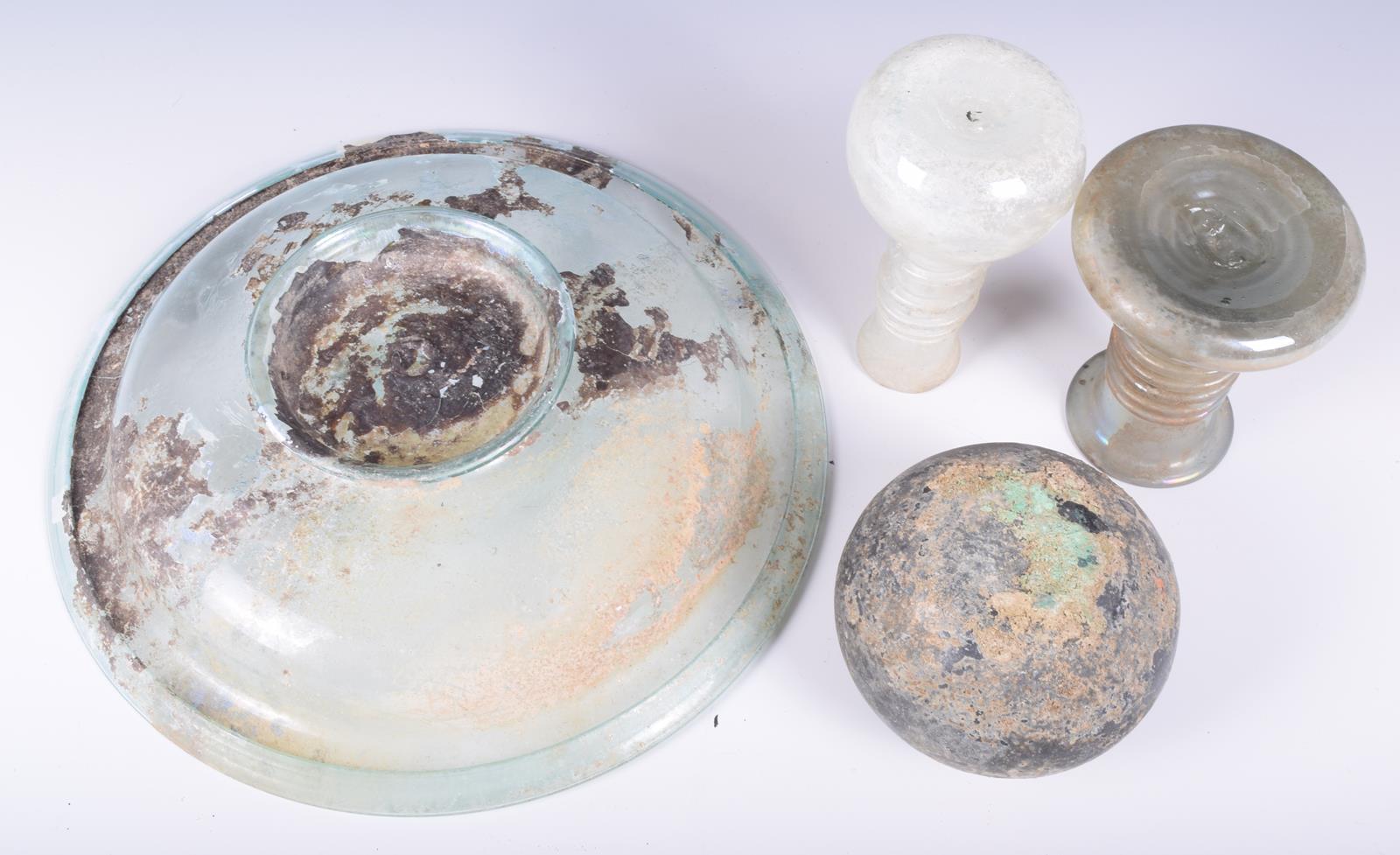 A Roman glass circular dish, on a spreading foot, 21.5cm diameter, two glass vessels with spiral - Image 4 of 4