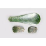 A Maori nephrite patu, with grooved terminal and pierced attachment aperture, 27cm long and two