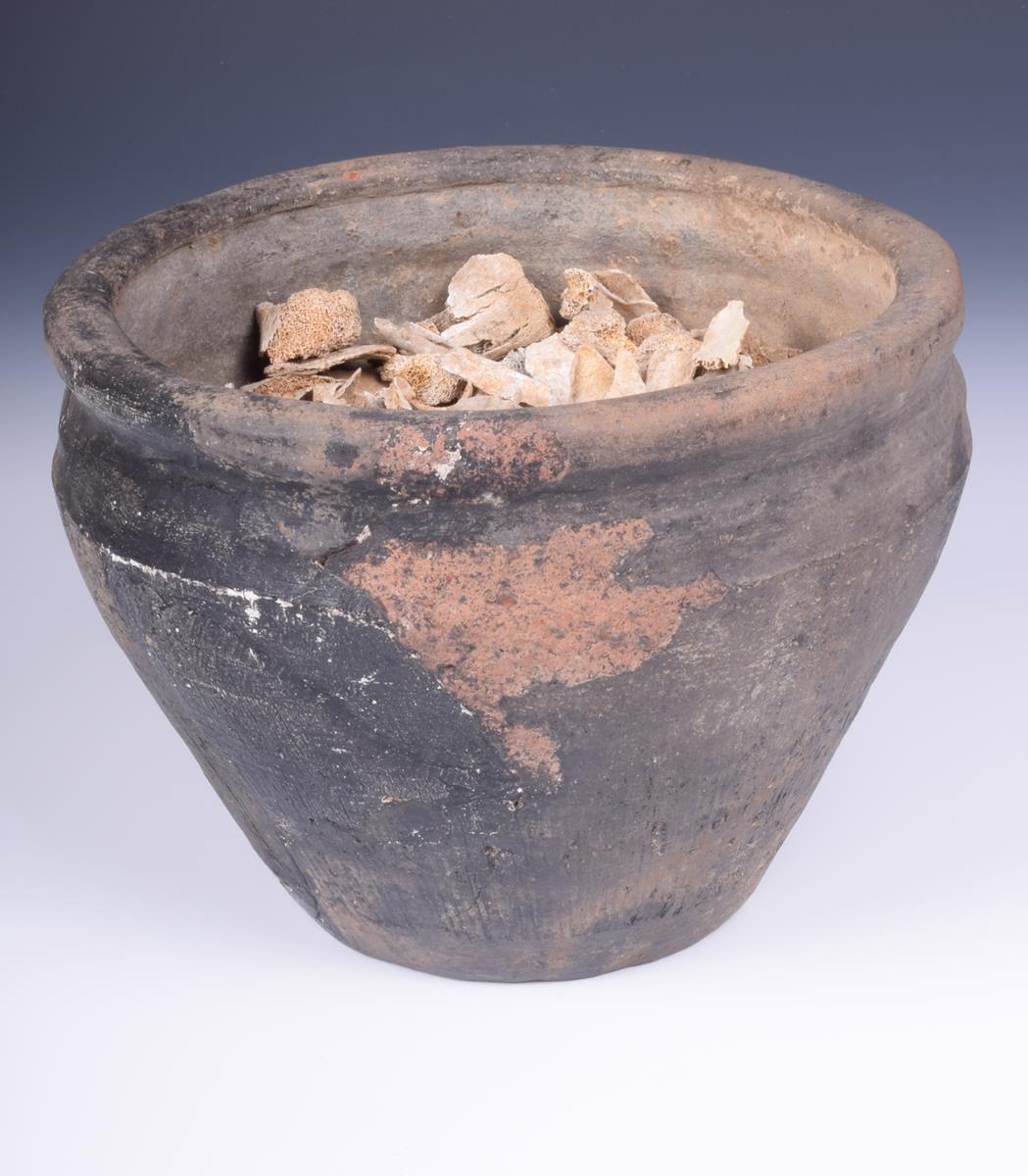 A bronze age earthenware cremation urn, with incised linear decoration to the sides, 15cm high, - Image 2 of 2