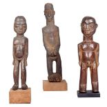 A Lobi standing male figure, Burkina Faso, with arms to the side, 20.5cm high with a stand and two
