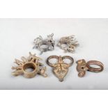 Five Ashanti brass alloy rings, Ghana, three with bulls and vegetation, one with a chameleon and the
