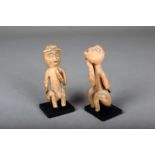 Two Northwest Coast Shaman figures; a seated suspected witch with arms behind her back, with long