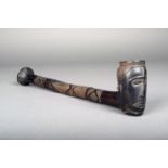 A Kuba pipe, D.R.Congo, carved wood in three sections with a head bowl and geometric decoration,