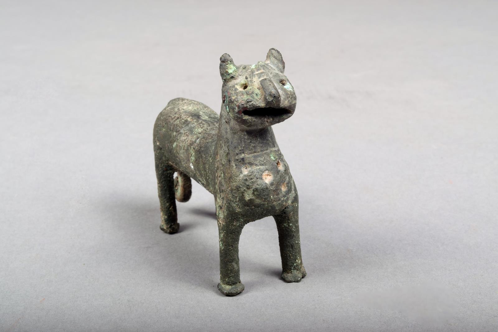 A Elamite bronze feline animal, with a pierced panel chest and scroll tipped tail, 6.5cm high.