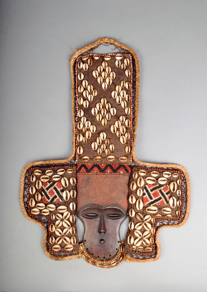 A Lele style mask, with fabric, bead and shell attachments, 53cm high.