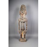 A Papua New Guinea female ancestor figure, with shell eyes and fibre adornment, 125.5cm high.