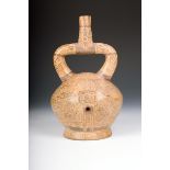 A Moche pottery stirrup vessel, decorated all over with a burial theme with figures and birds,