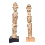 A Lobi standing female figure, Burkina Faso, with angled arms and bent legs, 34cm high on a stand