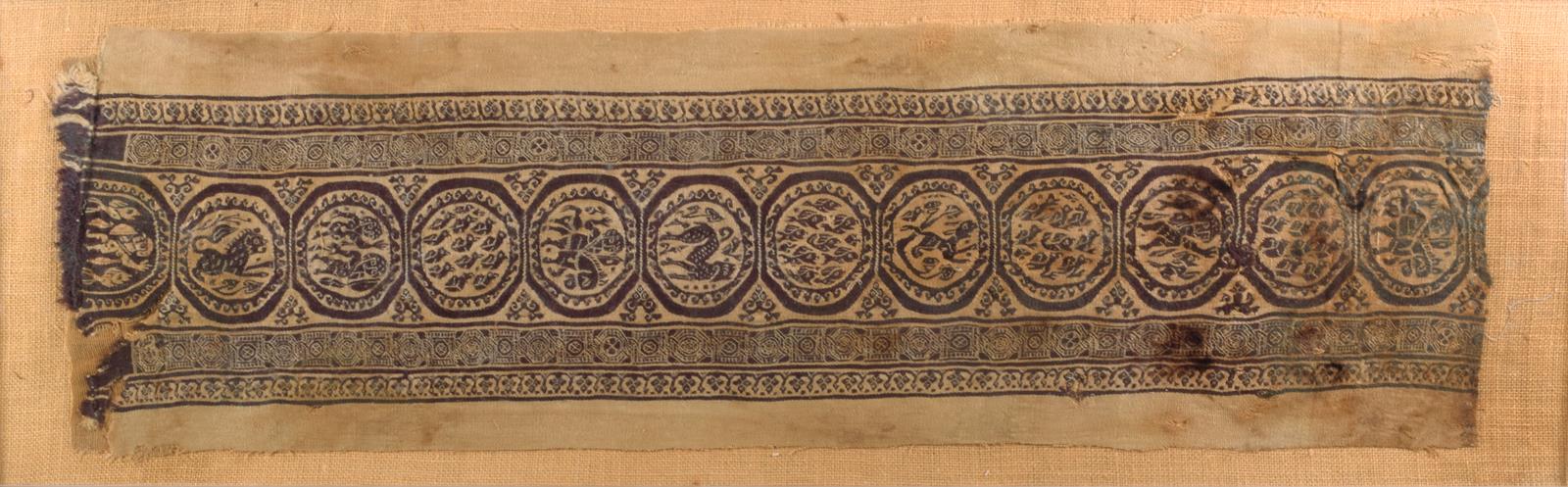 An Egyptian Coptic textile fragment, linen and wool, with a central band of roundels depicting