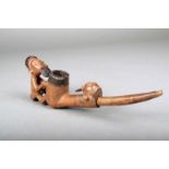 A Teke pipe, D.R.Congo, carved wood with tin, with a seated figure having blackened coiffure and