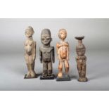 Four Lobi fetishes, Burkino Faso, differing standing figures, three with stands, 18.5cm the highest.