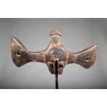 A Senufo sejen bird, Ivory Coast, with spread wings and three pierced holes, 37.2cm wide, on a