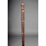 A Maori cane, carved with tiki with shell eyes, 87.5cm long.