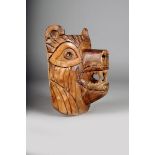 A Northwest Coast carved wood bear mask, with exposed teeth and burnt decoration, 23cm high.