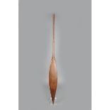 A Maori hoe, paddle, with a flat sided elongated leaf shape blade and a rounded shaft and knop