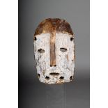 A Lega mask, D.R.Congo, carved wood with white pigment, 19cm high.