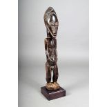 A Baule standing male figure, Ivory Coast, with fine linear coiffure and ribbed beard, face and body