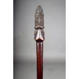 A Maori taiaha, with carved tiki Janus mask and tongue, reduced and pierced, 83cm long. Provenance