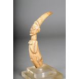 A Luba carved hippopotamus tusk, D.R. Congo, a female figure, 17cm high, with stand. (2)